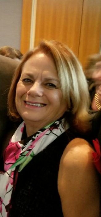 Kathy Tenuta wearing a black shirt with scarf