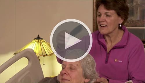 Still shot from a video of a nurse combing a patient's hair