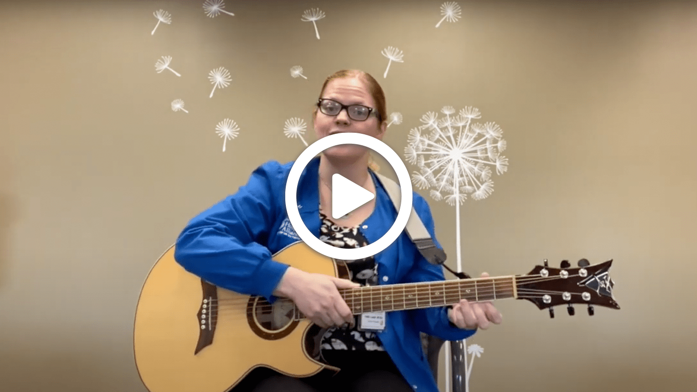 Hospice Alliance Music Therapist, Heidi, playing the guitar and singing hymns