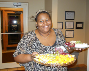 Event volunteer holding two fruit platters