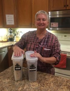 Tammy standing with two containers of cereal in a kitchen