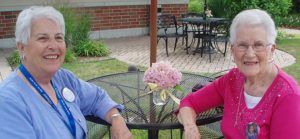 Two women sitting outside at a table