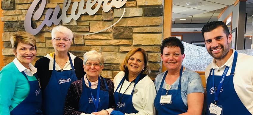 Employees at a Culvers restaurant give donations to Hospice Alliance