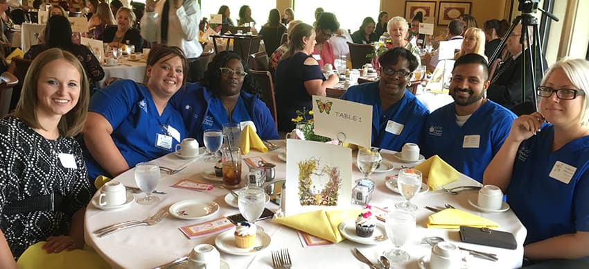 Hospice Alliance professionals sitting at a table at an event