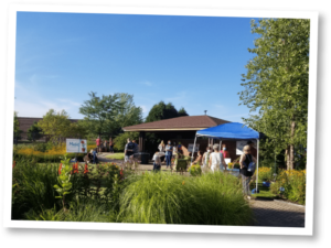 Connections Event at a part pavillion with people standing around wearing face masks